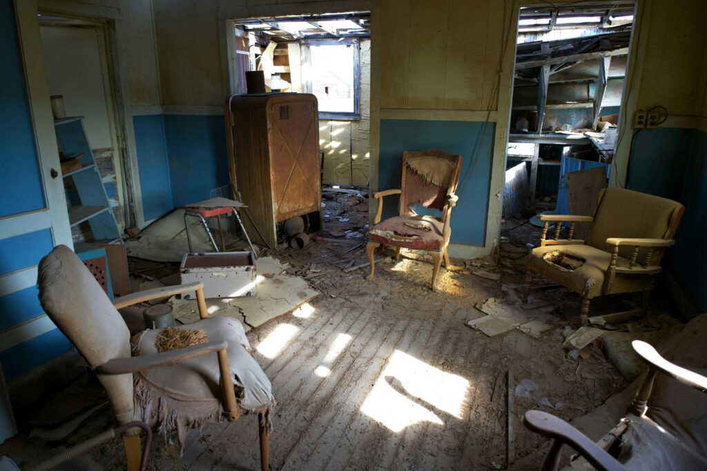 A room full of old, dusty junk furniture that will be removed and hauled away