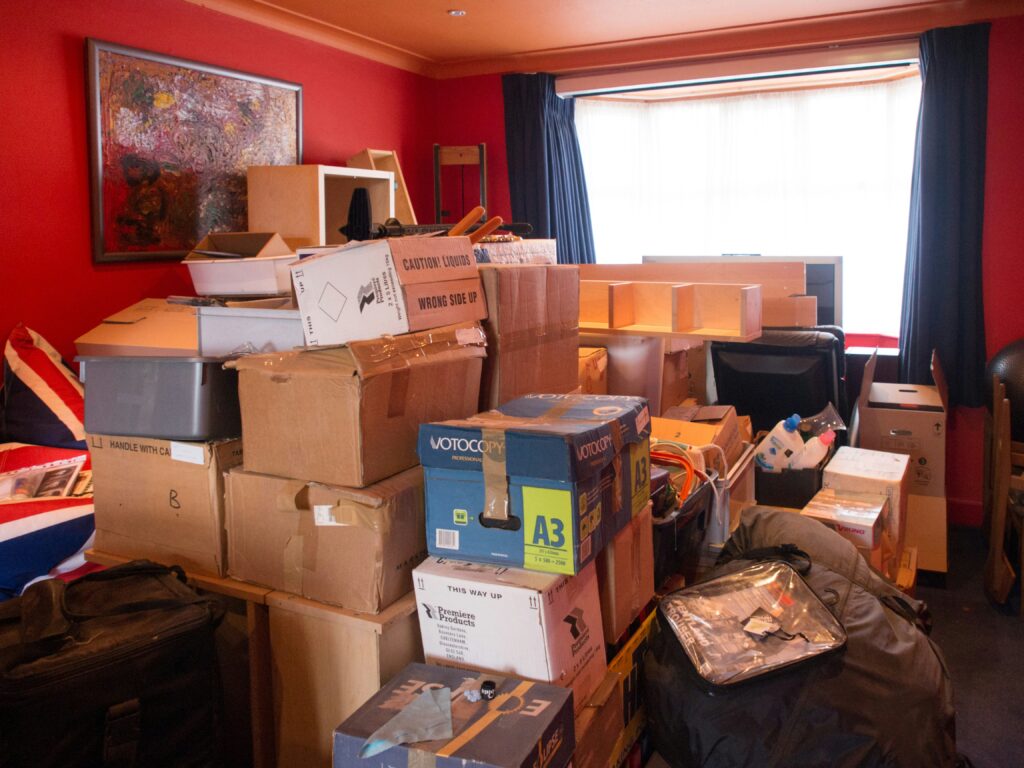 A red, cluttered room full of boxes and junk