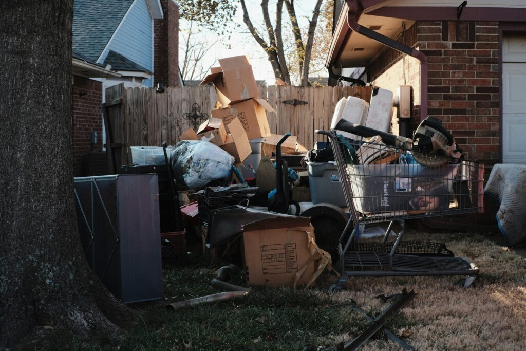 Cardboard, Mattresses and Trash piled up outside a residential home