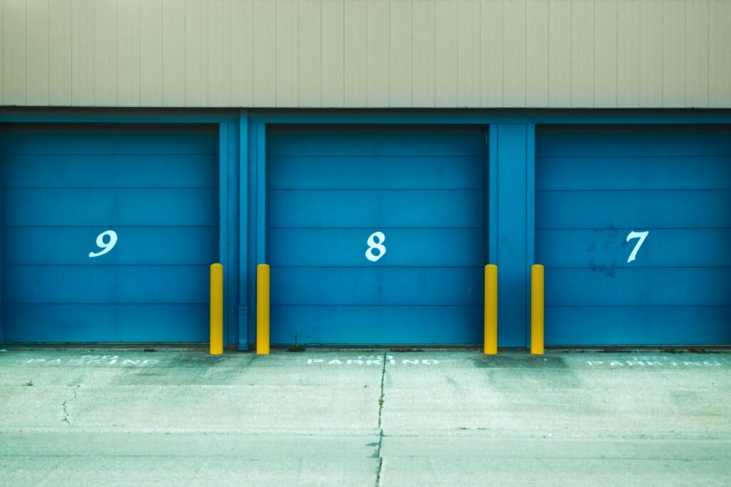Blue storage units, numbered 7 -9 with vehicle bumper protectors